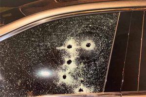 Car windows with gun shots.